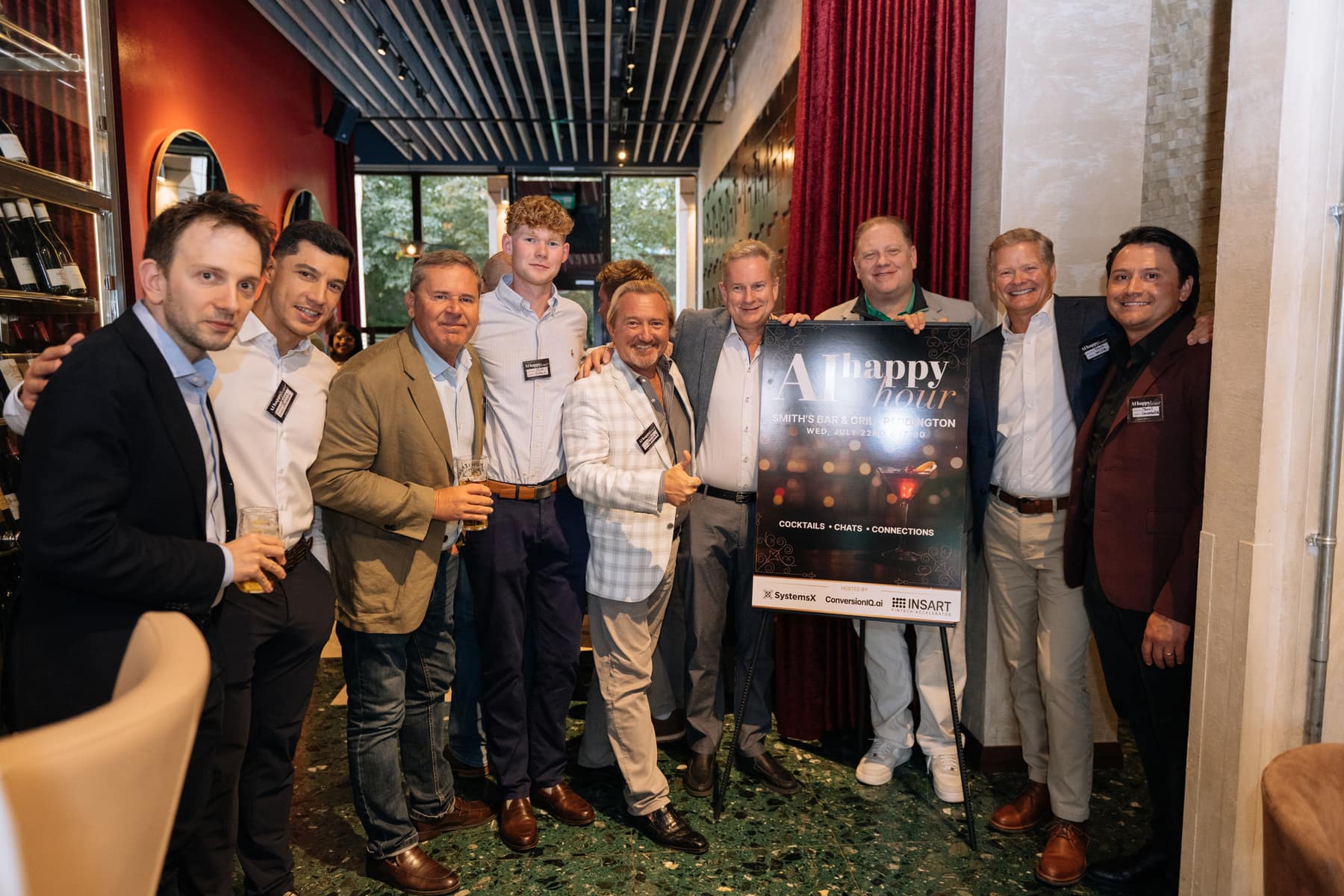 Guests gathered around the AI Happy Hour banner at Smith's Bar & Grill, Paddington