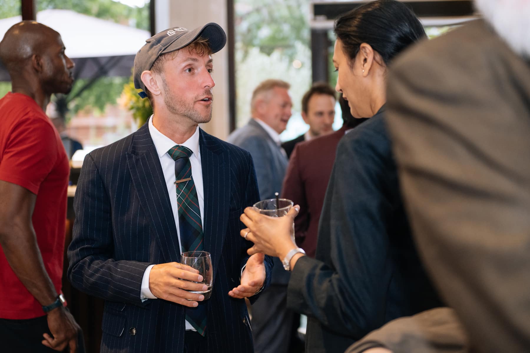 Two guests mid-conversation, at the London AI Happy Hour in July 2026