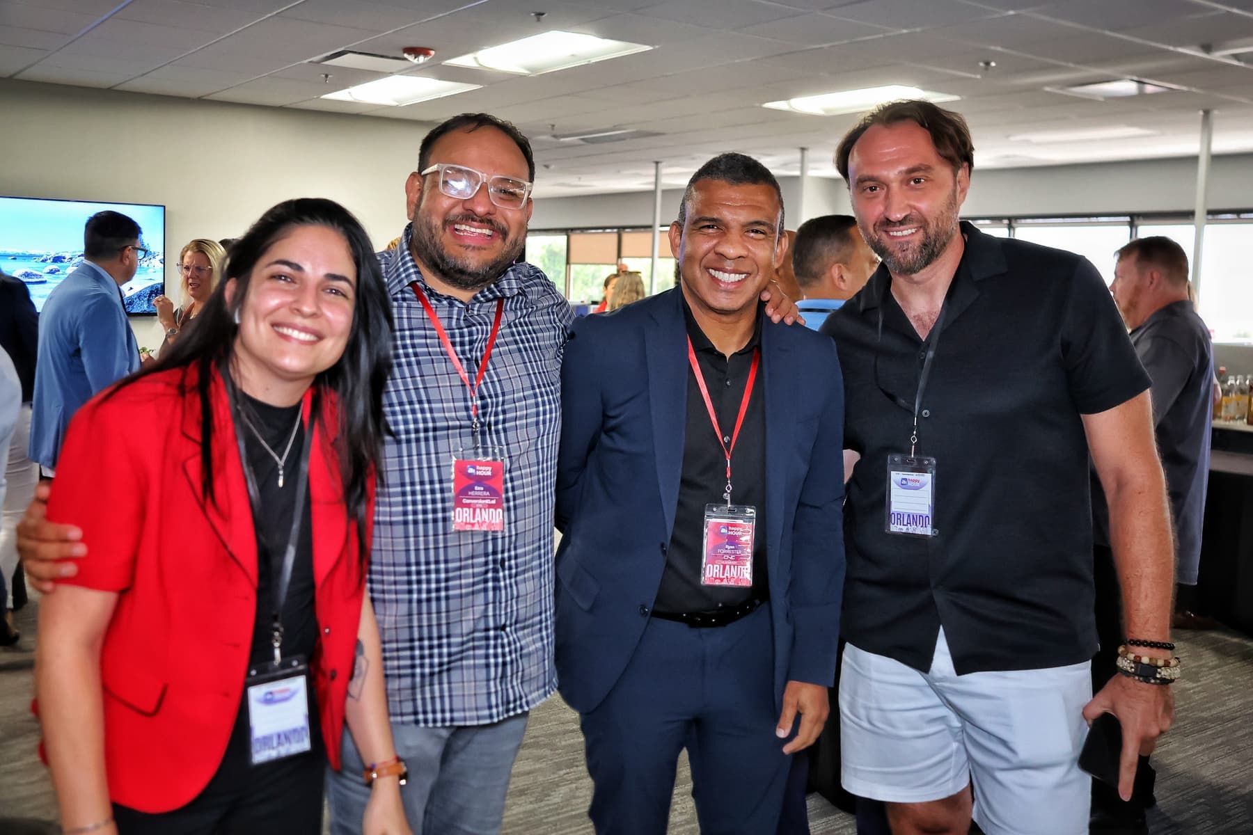 Guests together at AI After Hours: Orlando, event badges around their necks